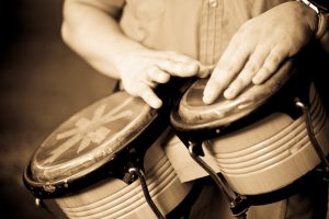 Hands playing bongo.