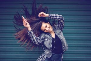 Happy girl enjoying music from mp3 player
